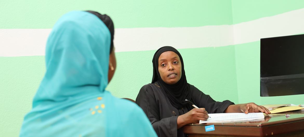 A counselor at the Victims of Violence Listening and Protecting Service speaks to a victim of sexual violence in Moroni, the capital of The Comoros.